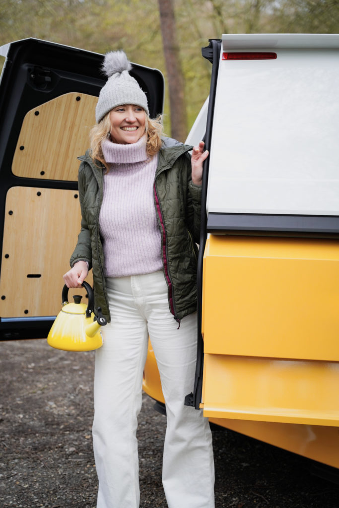 A person standing outside their campervan