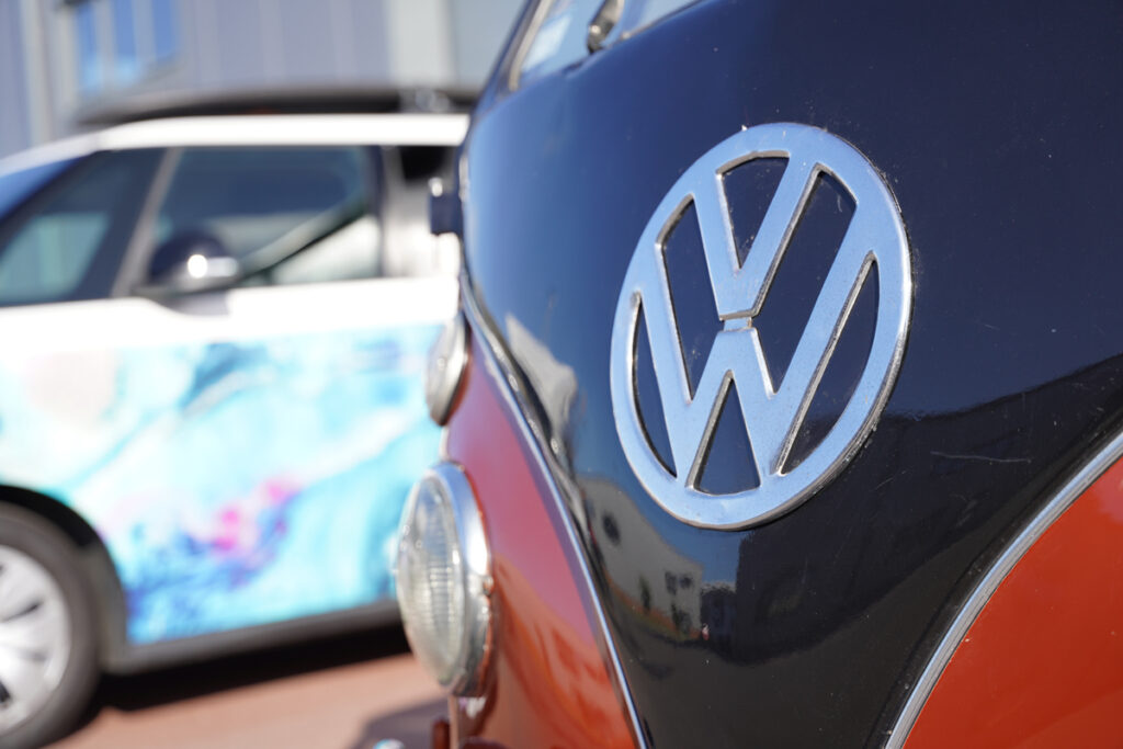 A classic VW camper alongside the new VW ID Buzz